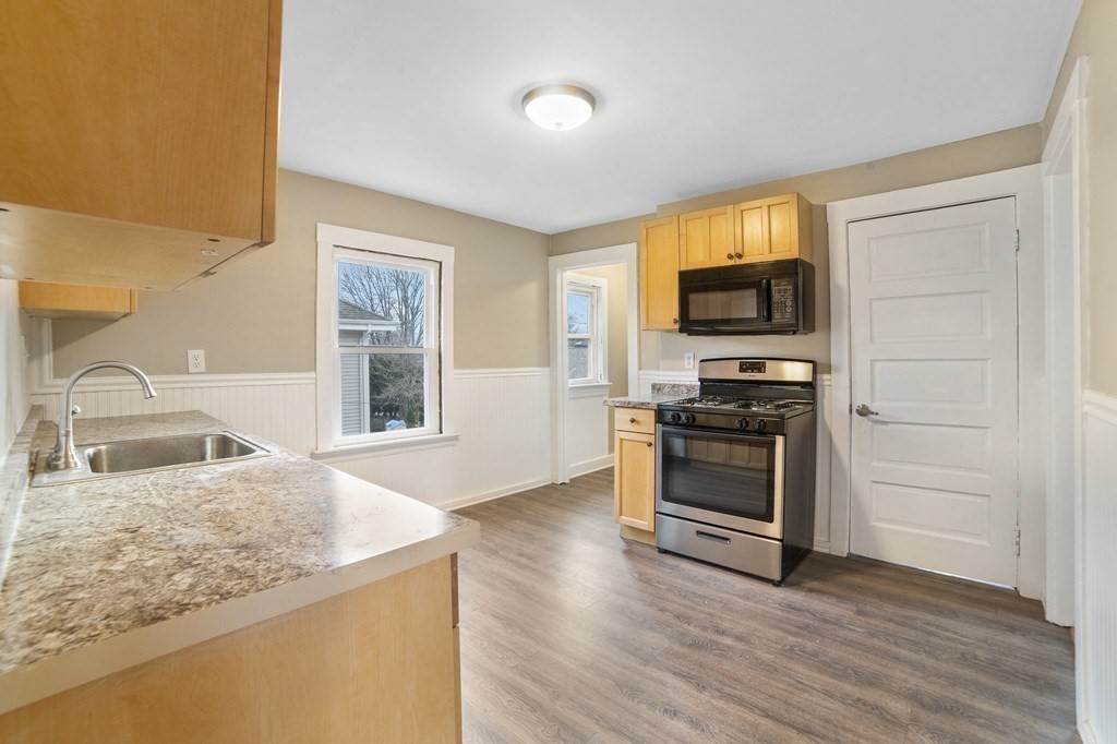 22 Ridgeway Street, Unit 2 Quincy, MA 02170 - Photo 1 of 15 a kitchen with granite countertop a stove and a sink