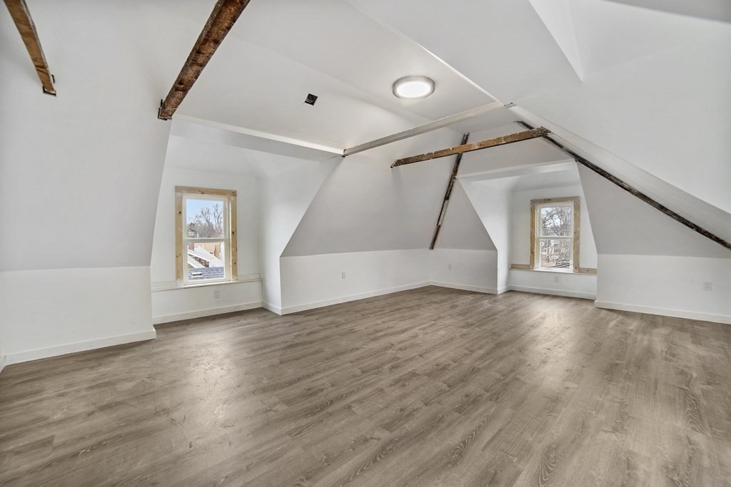 22 Ridgeway Street, Unit 2 Quincy, MA 02170 - Photo 11 of 15 a view of an empty room with wooden floor and stairs