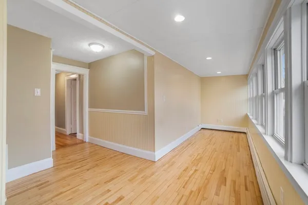a view of a hallway with wooden floor