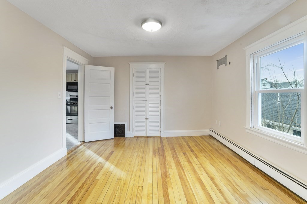 22 Ridgeway Street, Unit 2 Quincy, MA 02170 - Photo 6 of 15 a view of a room with wooden floor and a window