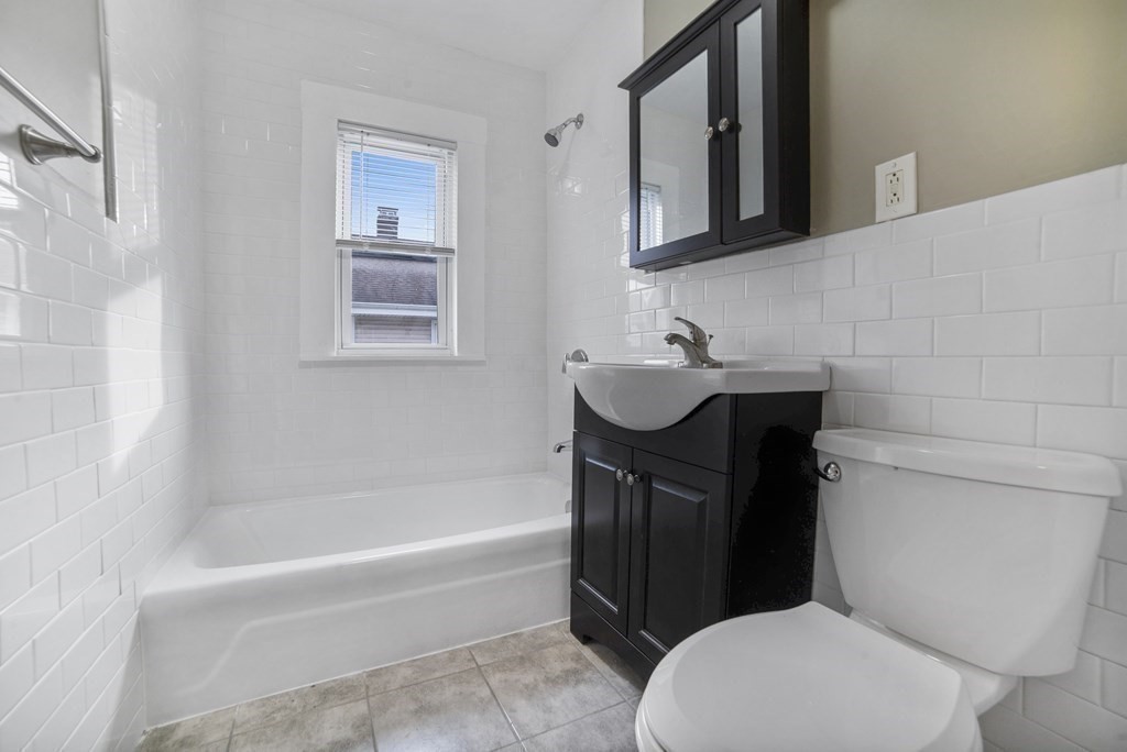 22 Ridgeway Street, Unit 2 Quincy, MA 02170 - Photo 10 of 15 a bathroom with a sink a toilet and bathtub