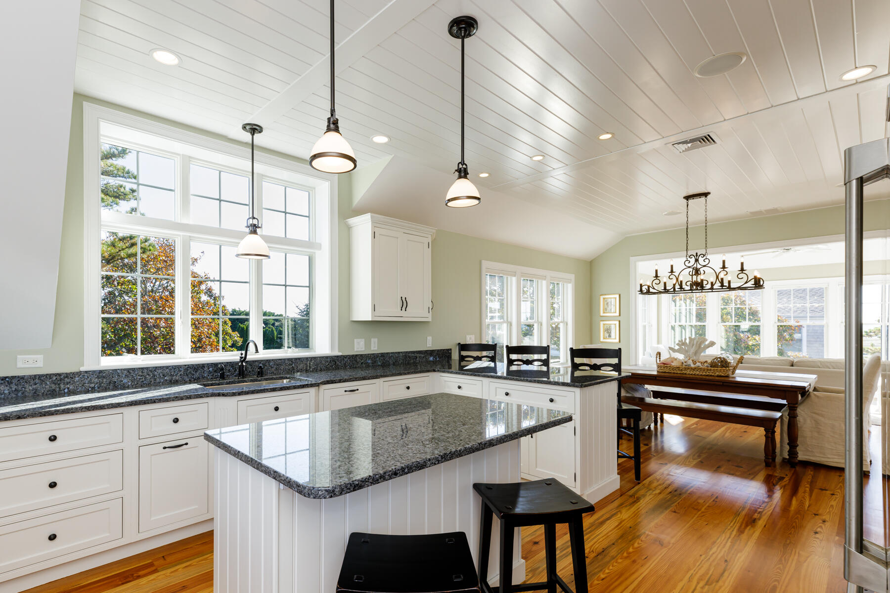 27 Patterson Road Chatham, MA 02633 - Photo 13 of 68 a kitchen with granite countertop a stove a sink a dining table chairs and chandelier