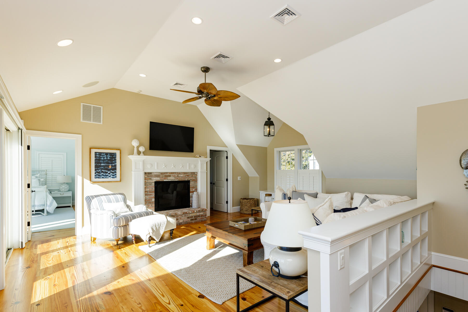 27 Patterson Road Chatham, MA 02633 - Photo 15 of 68 a living room with a fireplace furniture a rug and a chandelier