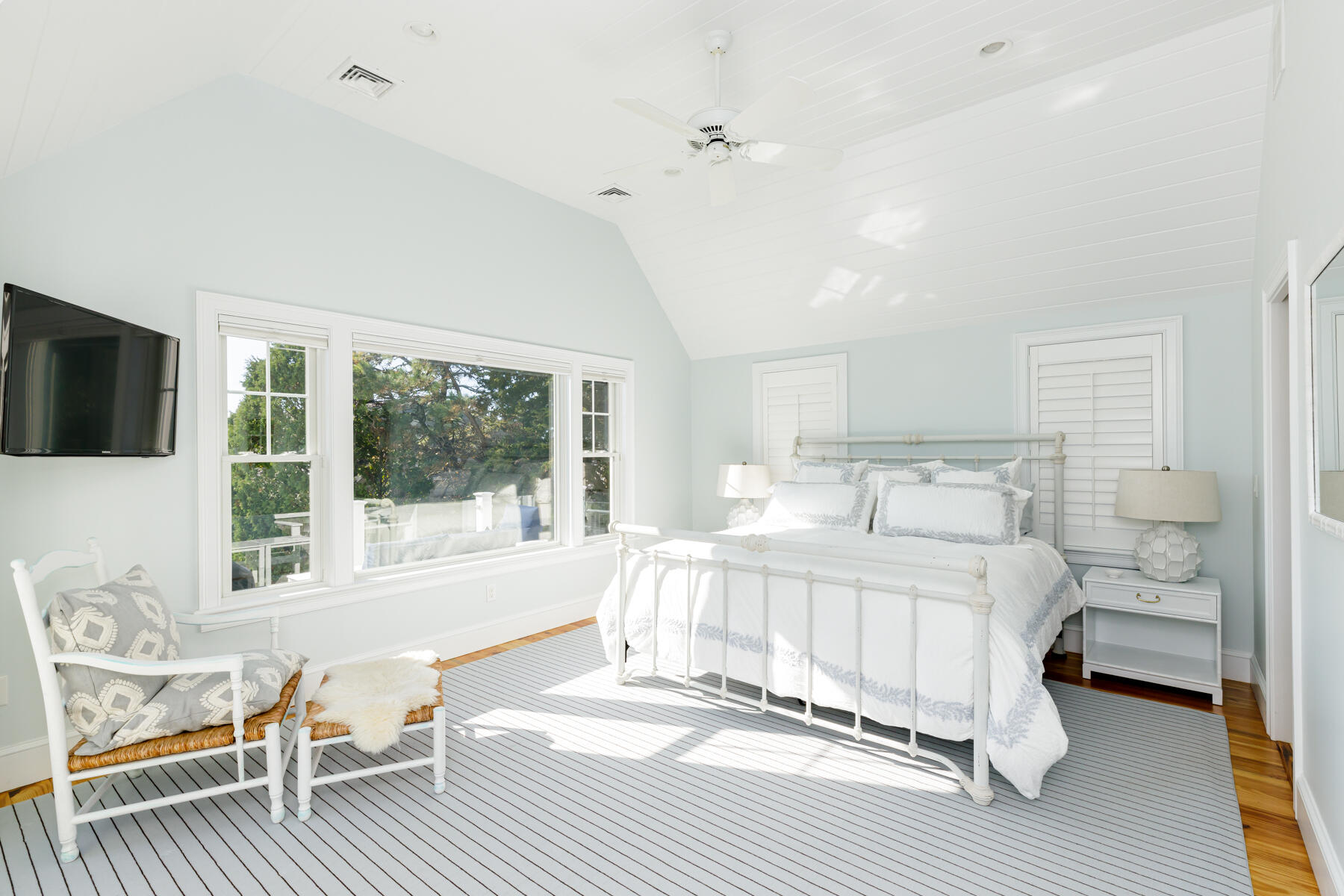 27 Patterson Road Chatham, MA 02633 - Photo 20 of 68 a large white bedroom with a large window and a wooden floor
