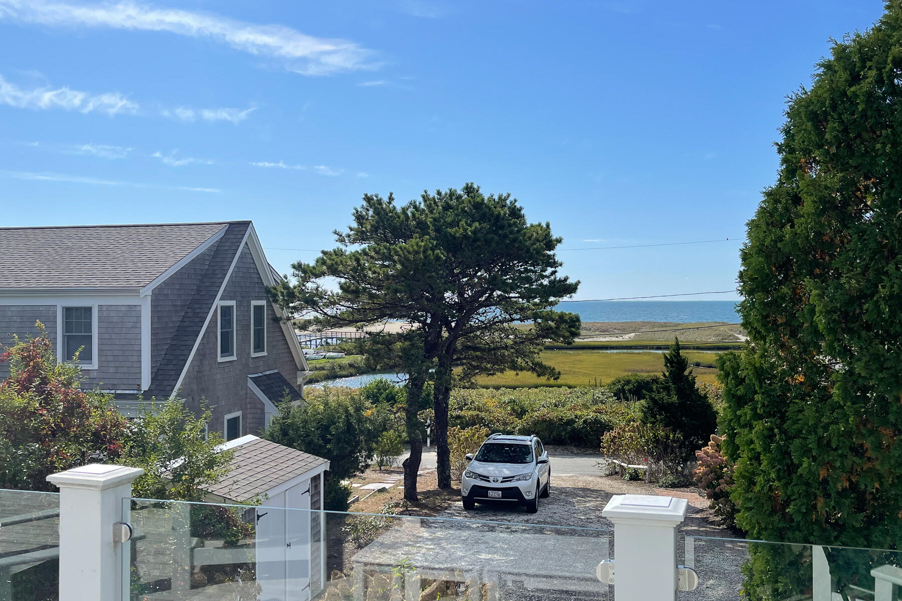 27 Patterson Road Chatham, MA 02633 - Photo 46 of 68 a view of a patio with table and chairs plants and palm trees
