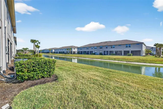 a view of a house with a yard and a swimming pool