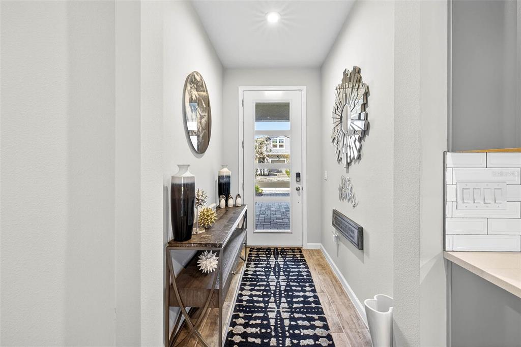 25993 Woven Wicker Bend Lutz, FL 33559 - Photo 24 of 45 a view of a hallway with wooden floor and a bathroom