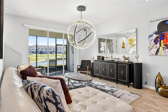 a spacious bedroom with a bed a dresser and a large window