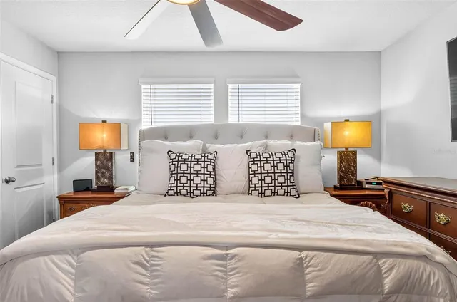 a bedroom with a bed and a lamp