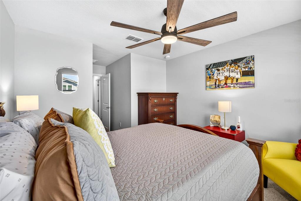 25993 Woven Wicker Bend Lutz, FL 33559 - Photo 40 of 45 a bedroom with a bed and a chandelier