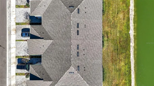 a bathroom with a granite countertop shower a sink and a mirror