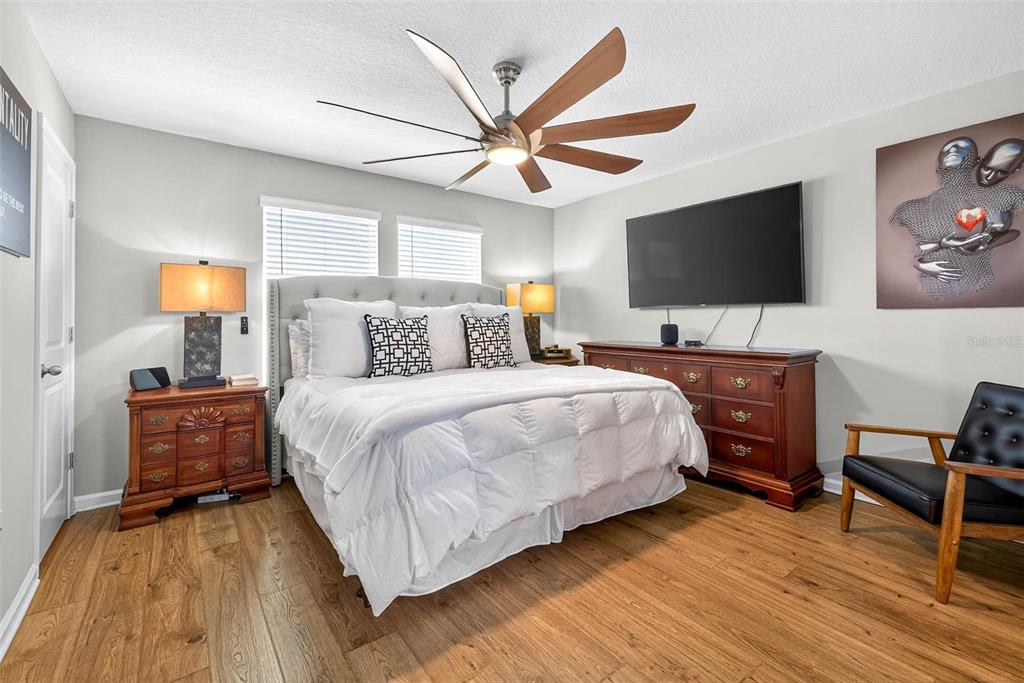 25993 Woven Wicker Bend Lutz, FL 33559 - Photo 6 of 45 a bedroom with a bed and a flat screen tv