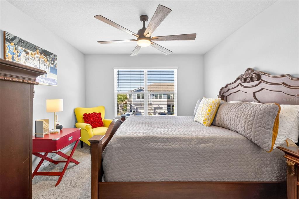 25993 Woven Wicker Bend Lutz, FL 33559 - Photo 10 of 45 a bedroom with a bed and wooden floor