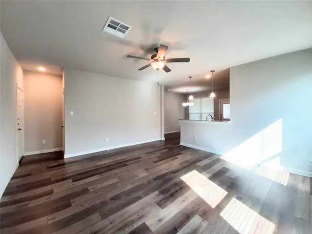 a view of an empty room with kitchen