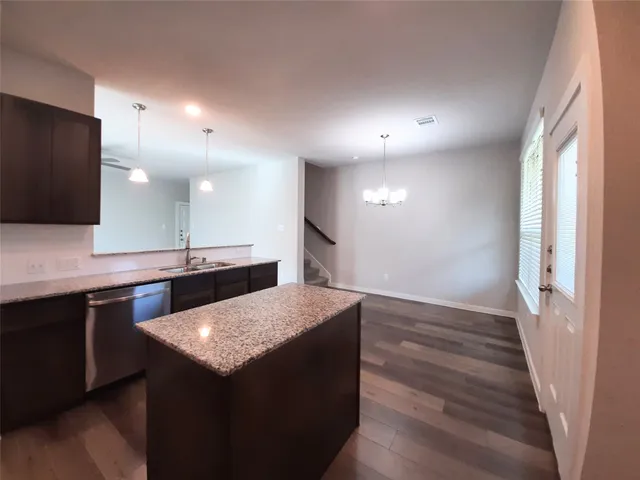 a kitchen with a sink and a refrigerator
