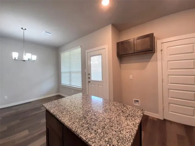 a view of kitchen island with tub and wooden floor
