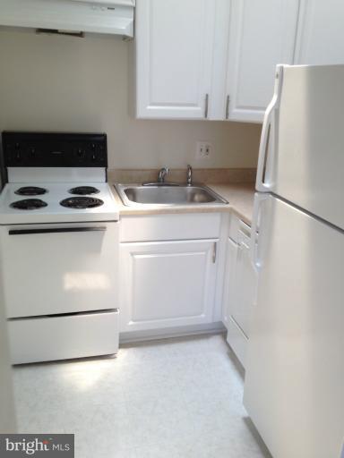 New cabinets, ceramic tile floor and fridge