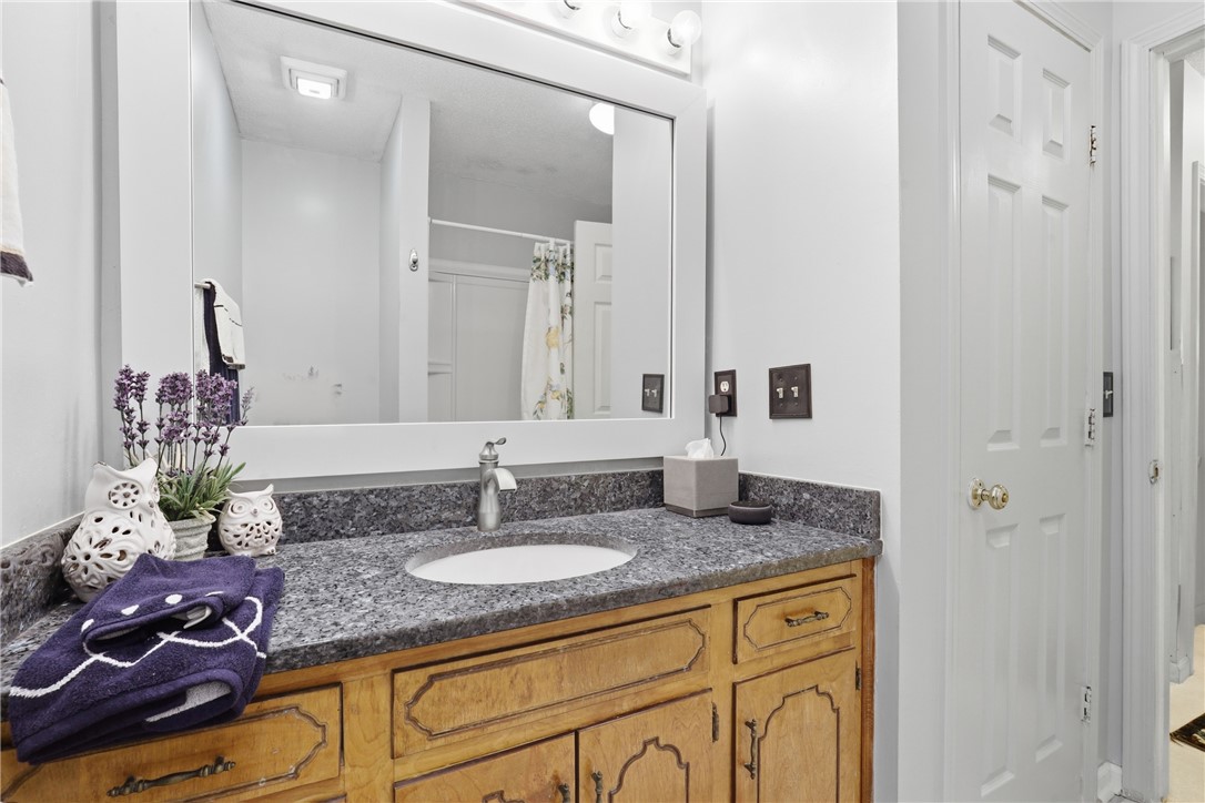 110 Shaftsbury Road Clemson, SC 29631 - Photo 18 of 38 This bathroom features a sleek vanity with granite counters and a clean, functional design.