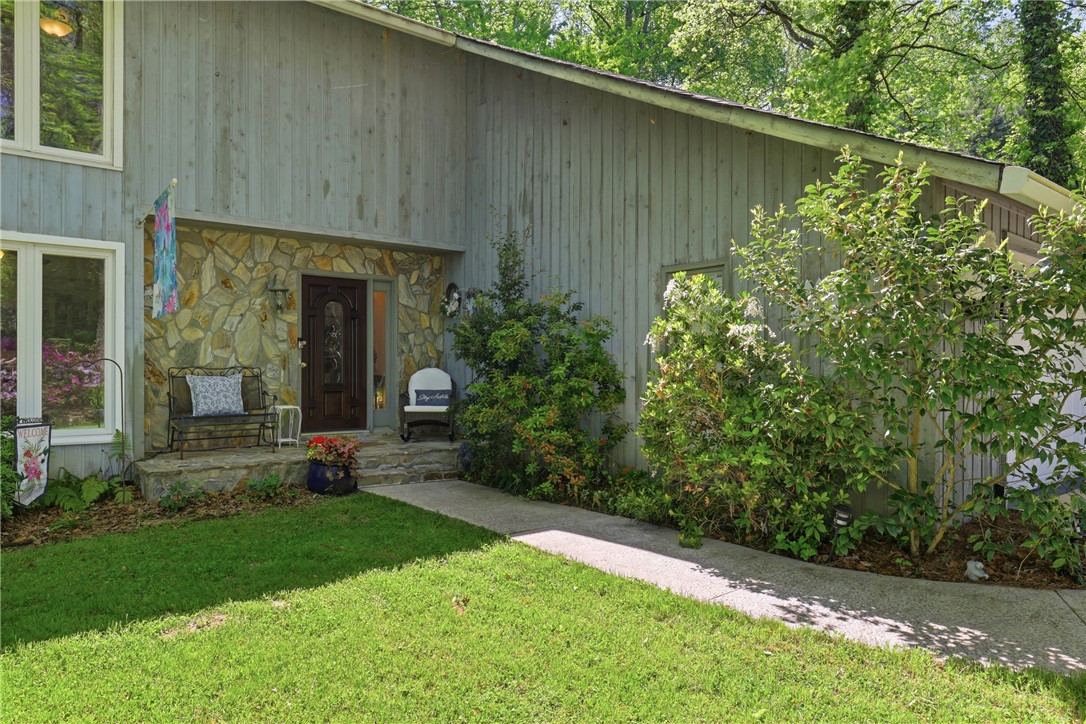 110 Shaftsbury Road Clemson, SC 29631 - Photo 2 of 38 This inviting home showcases a lovely entrance with natural stone accents and lush greenery.