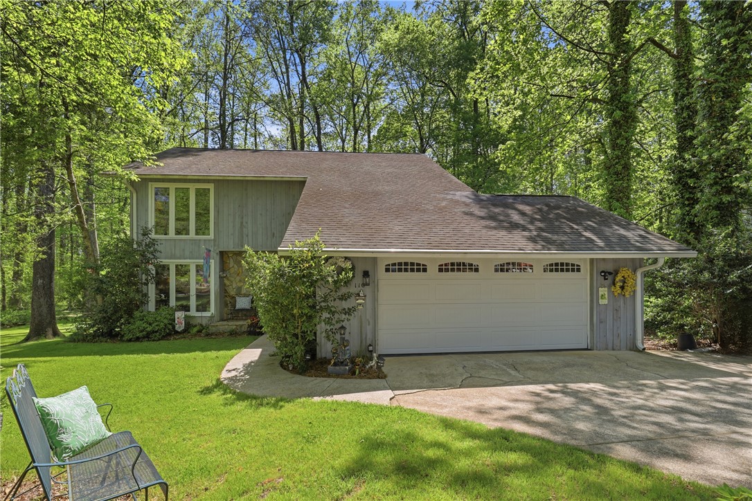 110 Shaftsbury Road Clemson, SC 29631 - Photo 30 of 38 This charming home features a classic exterior and a spacious driveway, nestled in a lush, wooded setting.