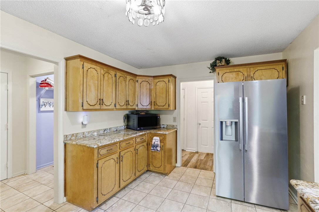 110 Shaftsbury Road Clemson, SC 29631 - Photo 10 of 38 This kitchen boasts natural wood cabinetry, granite countertops, and tile flooring, perfect for daily living.