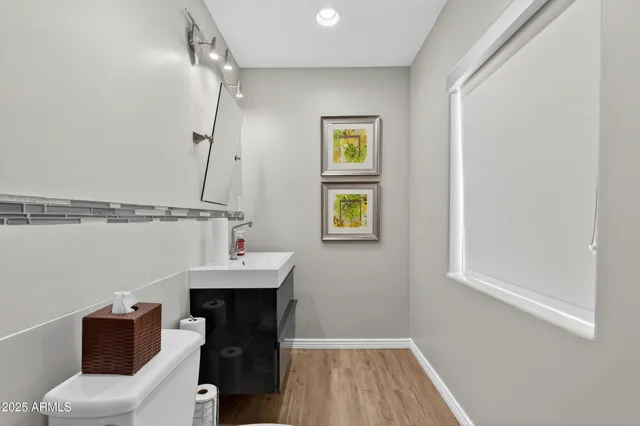 a bathroom with a sink mirror and toilet