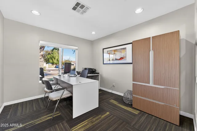 a view of a workspace with furniture and wooden floor