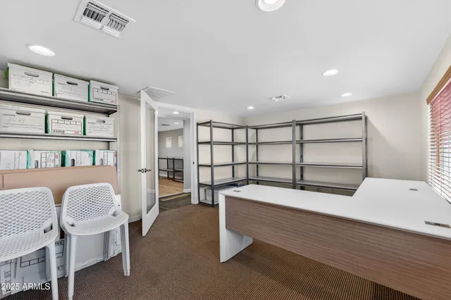 a bedroom with a bed and a book shelf