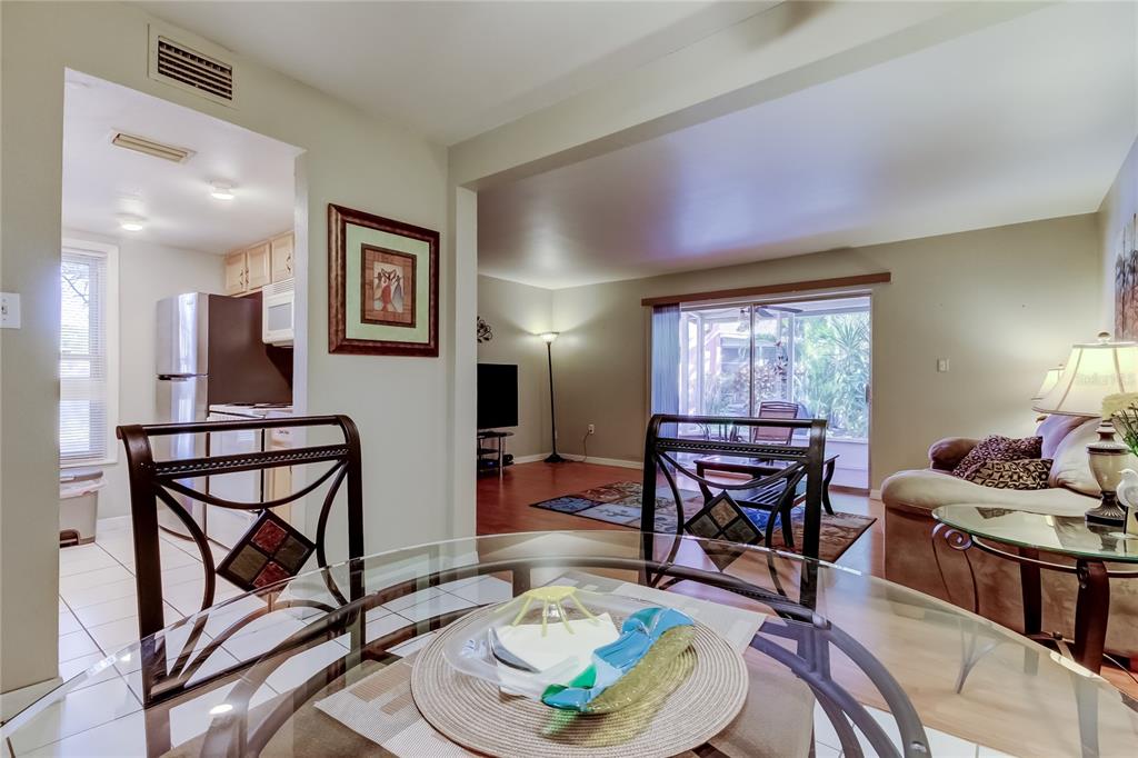 3650 41st Way South, Unit A St. Petersburg, FL 33711 - Photo 13 of 35 a living room with furniture a piano and wooden floor