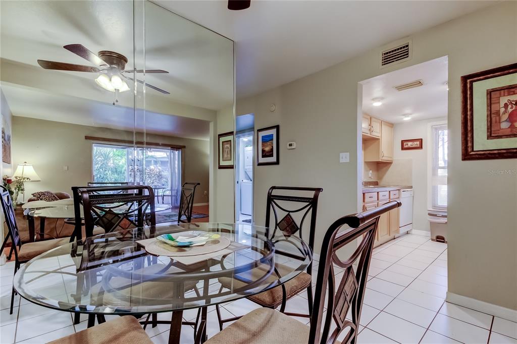 3650 41st Way South, Unit A St. Petersburg, FL 33711 - Photo 14 of 35 a view of a dining room with furniture and chandelier