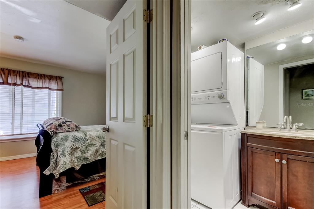 3650 41st Way South, Unit A St. Petersburg, FL 33711 - Photo 20 of 35 a bedroom with a bed and a mirror