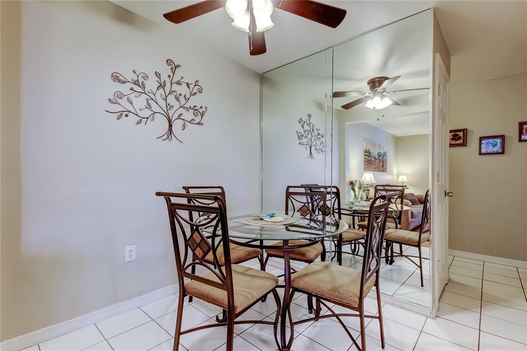 3650 41st Way South, Unit A St. Petersburg, FL 33711 - Photo 5 of 35 a view of a dining room with furniture and a chandelier fan