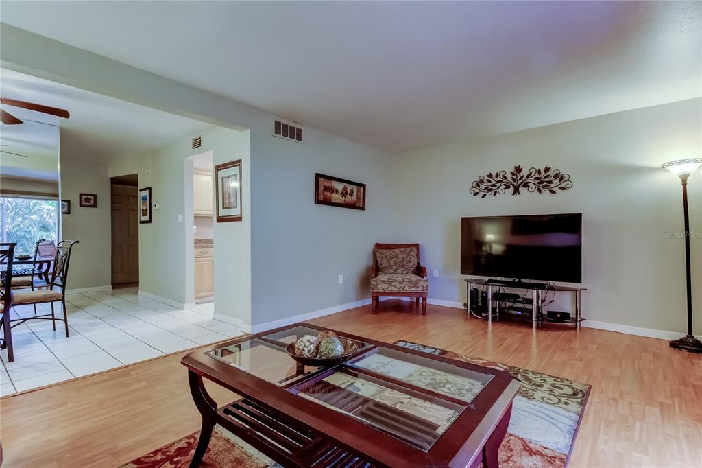 3650 41st Way South, Unit A St. Petersburg, FL 33711 - Photo 7 of 35 a living room with furniture and a flat screen tv