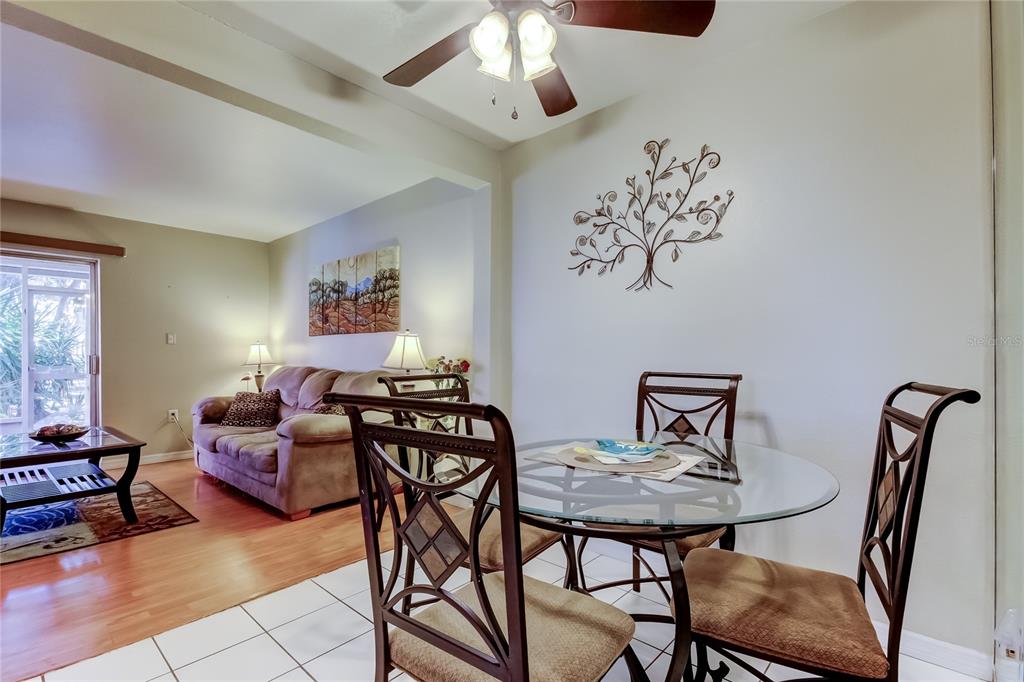 3650 41st Way South, Unit A St. Petersburg, FL 33711 - Photo 8 of 35 a living room with furniture and a chandelier