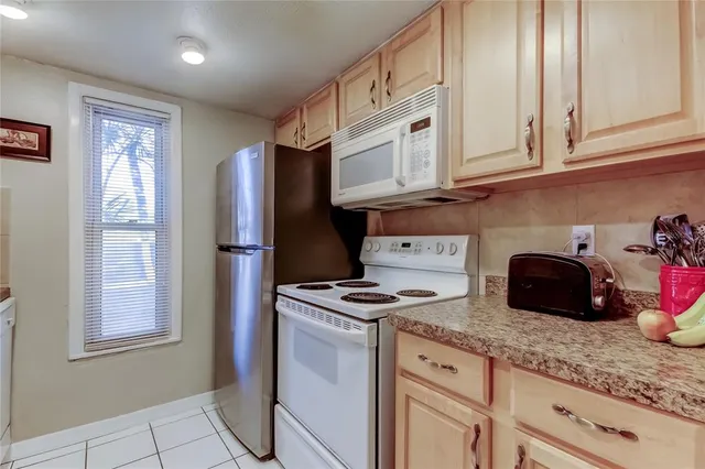 a kitchen with granite countertop cabinets and steel stainless steel appliances