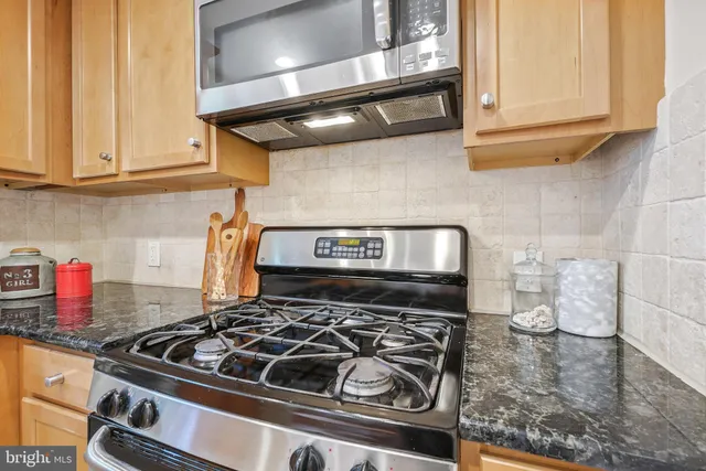 a stove top oven sitting inside of a kitchen