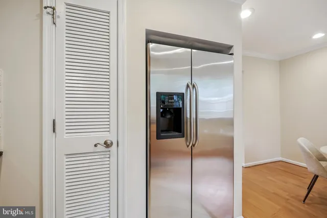 a view of a hallway with wooden cabinets