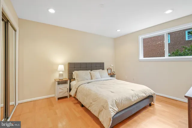 a bedroom with a bed and a large window