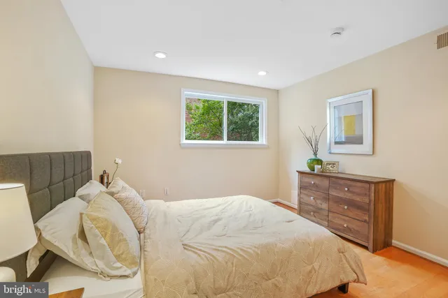 a bedroom with a bed and a dresser