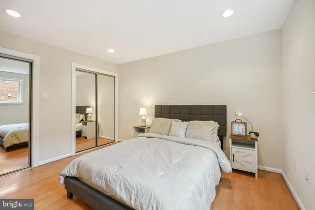 a bedroom with a bed and a mirror