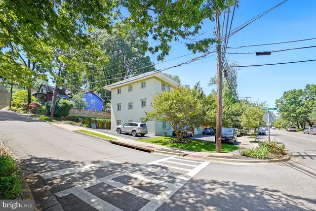 a view of a house with a yard and tree s