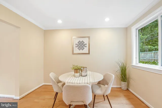 a view of a livingroom with a table and chair