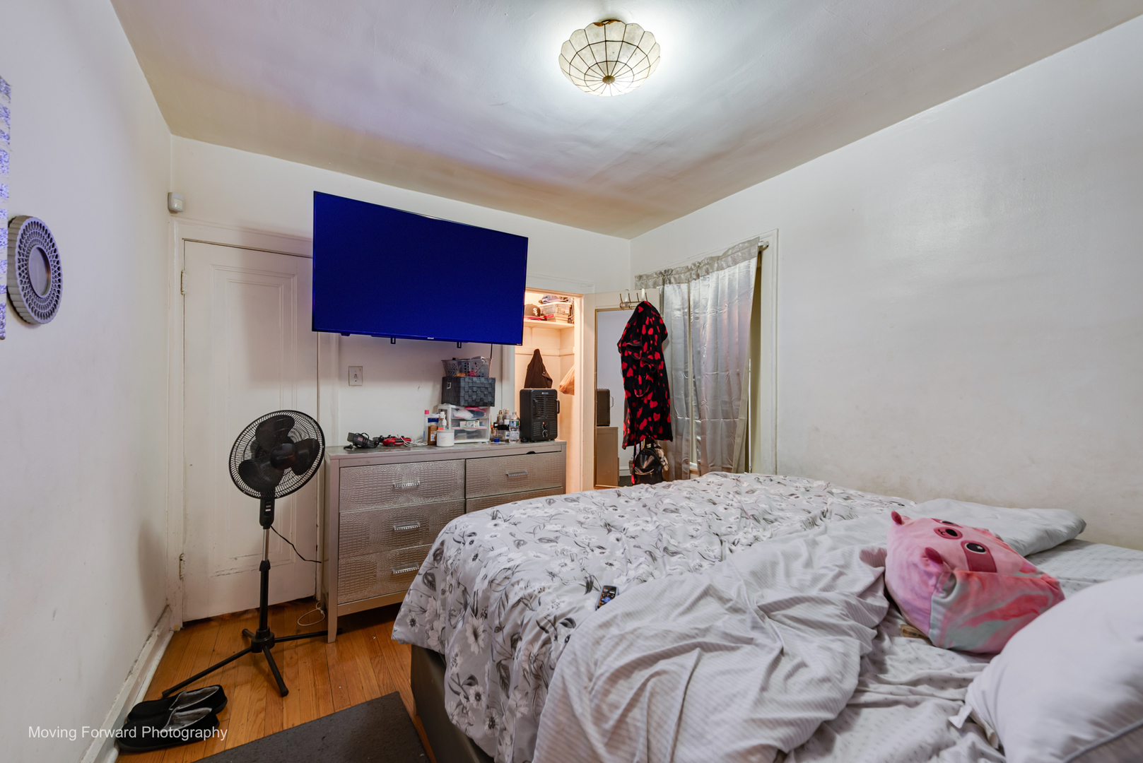 8213 South Indiana Avenue Chicago, IL 60619 - Photo 10 of 25 a bedroom with a bed and a table in it