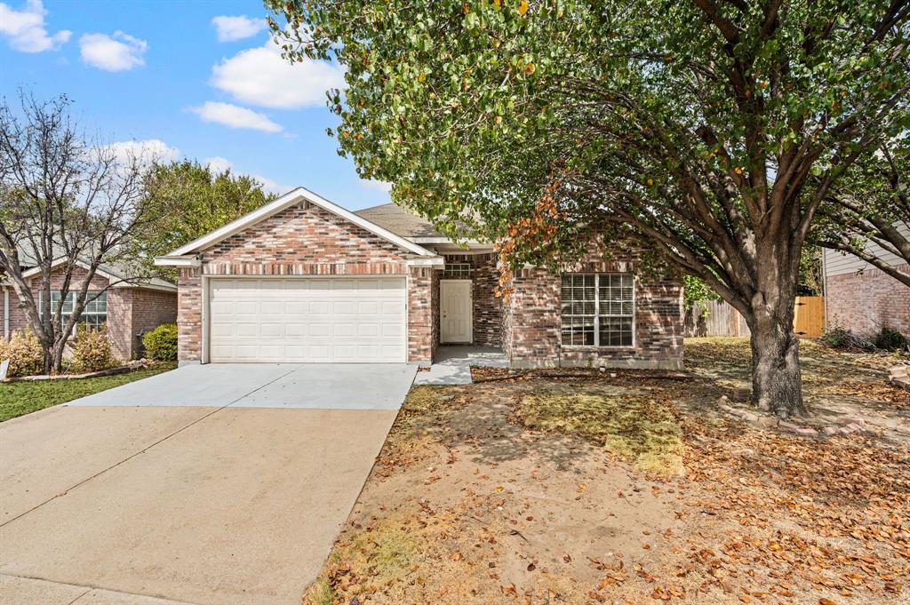 5509 Timber Ridge Court Watauga, TX 76137 - Photo 1 of 28 Brick exterior with a gabled roofline, an attached garage, and a concrete driveway