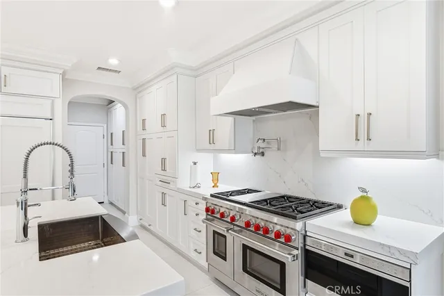 a kitchen with a stove a sink and a refrigerator