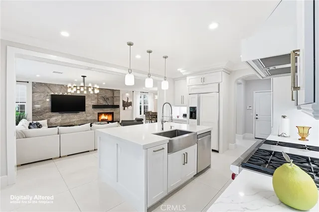 a kitchen with stainless steel appliances a stove a sink and a refrigerator
