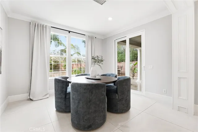 a dining room with table chairs and chandelier