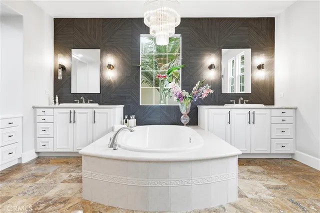 a bathroom with a bathtub a sink and a mirror