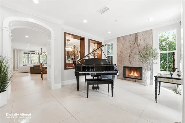 a living room with furniture a fireplace and a table