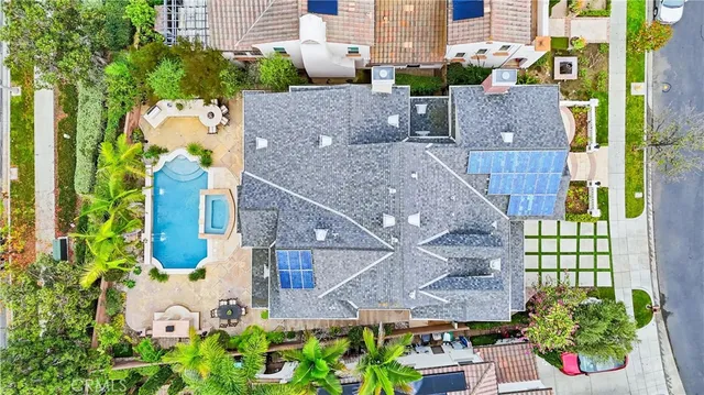 an aerial view of beach and residential houses with outdoor space